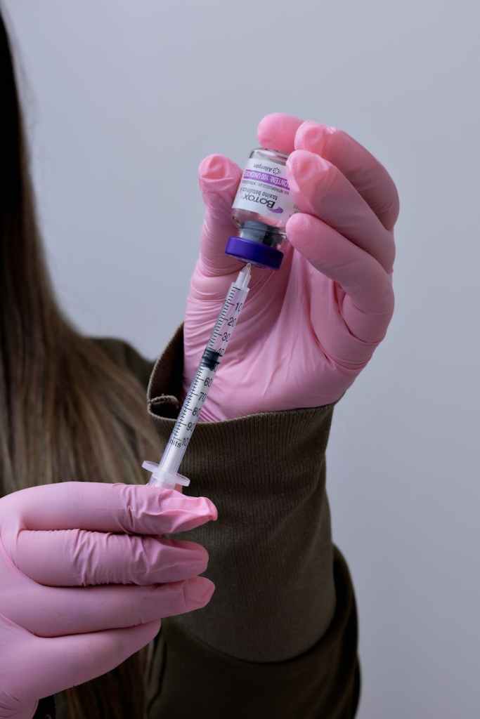 Woman with syringe for botox 
